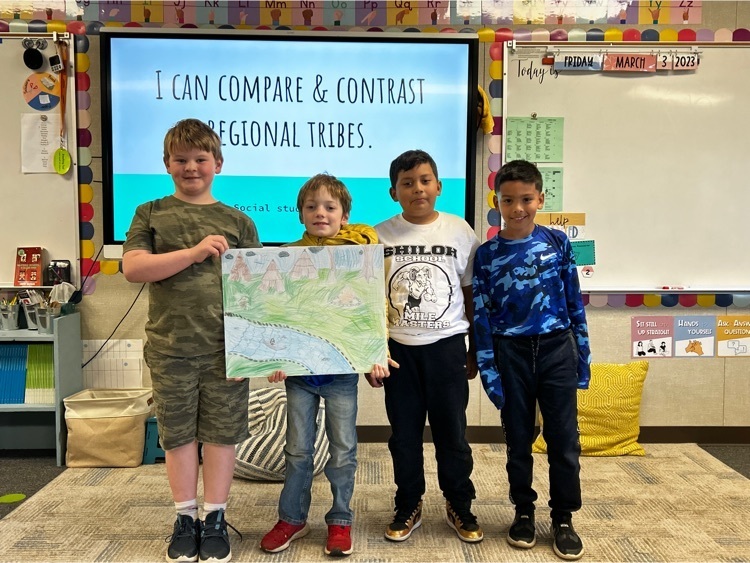 third grade students, holding a poster with a scene of the central valley in colored pencil.