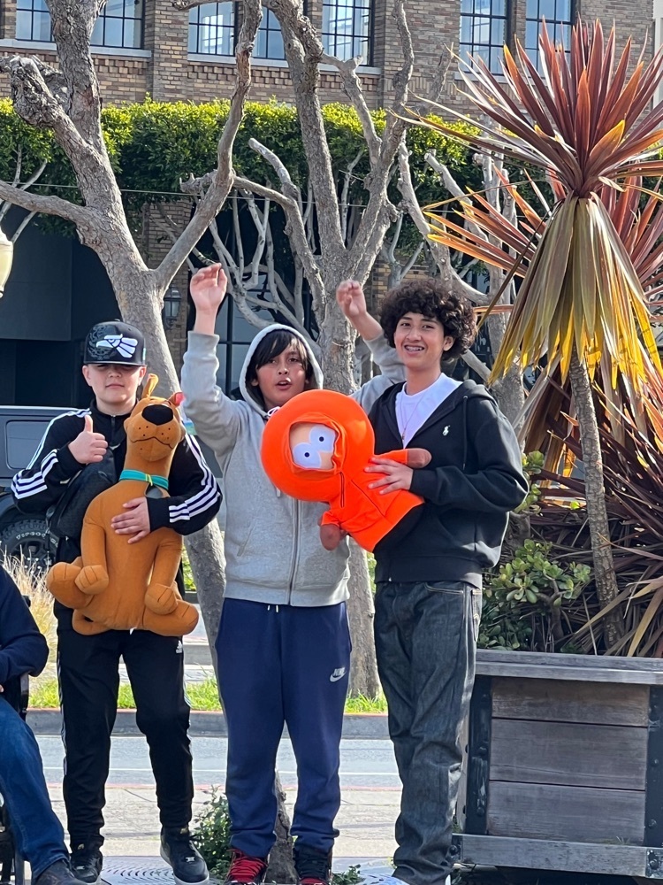 Students holding stuffed animal prizes