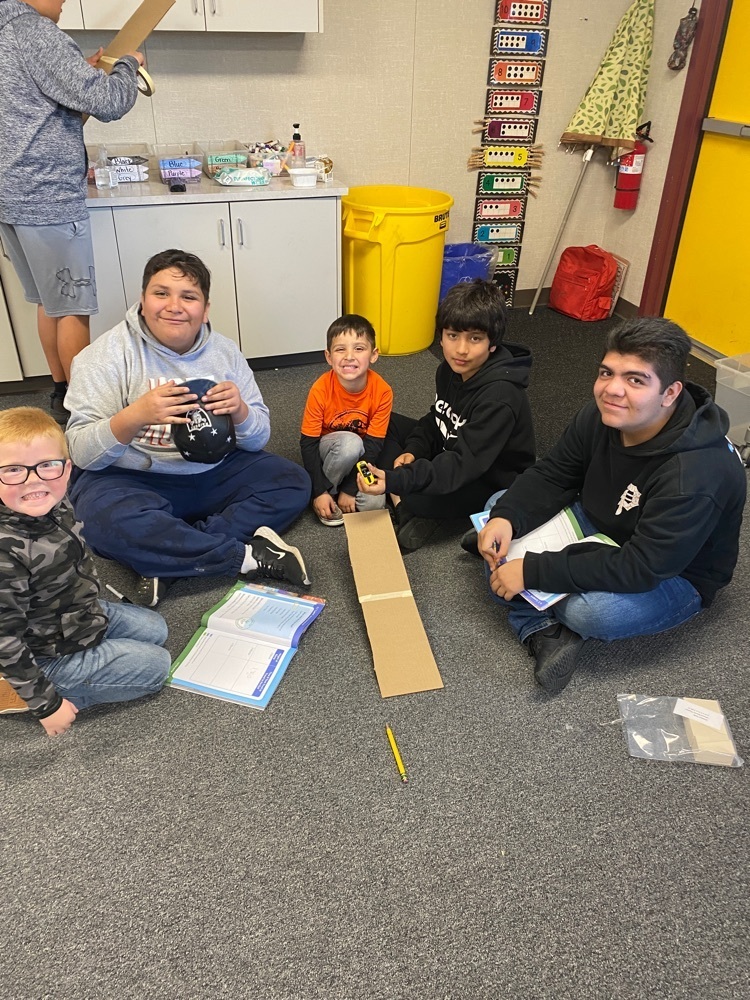 kindergarten and 8th grade students doing an experiment on gravity and speed